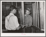 Farmer receiving check for sweet potatoes at starch plant. Laurel, Mississippi