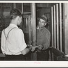 Farmer receiving check for sweet potatoes at starch plant. Laurel, Mississippi