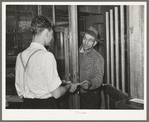 Farmer receiving check for sweet potatoes at starch plant. Laurel, Mississippi