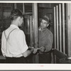 Farmer receiving check for sweet potatoes at starch plant. Laurel, Mississippi