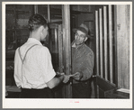 Farmer receiving check for sweet potatoes at starch plant. Laurel, Mississippi