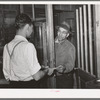 Farmer receiving check for sweet potatoes at starch plant. Laurel, Mississippi