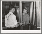 Farmer receiving check for sweet potatoes at starch plant. Laurel, Mississippi