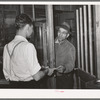 Farmer receiving check for sweet potatoes at starch plant. Laurel, Mississippi