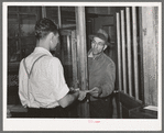 Farmer receiving check for sweet potatoes at starch plant. Laurel, Mississippi