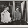 Farmer receiving check for sweet potatoes at starch plant. Laurel, Mississippi