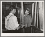 Farmer receiving check for sweet potatoes at starch plant. Laurel, Mississippi