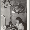 Mexican girl sewing in their home. Robstown, Texas. Contrary to the prevalent idea, Mexicans generally are extremely neat and clean even when they live in most crowded conditions