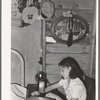 Mexican girl sewing in their home. Robstown, Texas. Contrary to the prevalent idea, Mexicans generally are extremely neat and clean even when they live in most crowded conditions