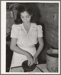 Mexican girl grinding peppers. Robstown, Texas