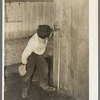 Mexican boy drinking out of water faucet. There were five of these faucets to supply water for about fifty Mexican families averaging five members each. They live in five units. Robstown, Texas