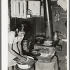 Mexican girl living in corral making tortillas. Tortillas can be seen baking on the stove. Robstown, Texas