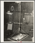 Mexican baby in swing bed in corral. Robstown, Texas