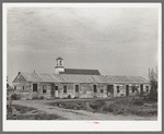 Mexican housing at Edcouch, Texas. Notice church in background