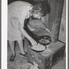 White migrant woman cooking cabbage in tent home. Edinburg, Texas