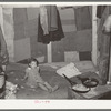 Interior of tent of white migrant family near Edinburg, Texas. Bed is on the floor. Tent was made of patched cotton materials of various sorts. The man said he had worked in a cotton mill in Dallas, Texas, and had obtained the materials then
