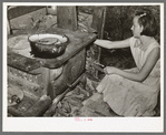 Daughter of white migrants reaching for stick of wood. Sebastian, Texas