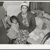 Mexican mother and child in home. Crystal City, Texas. This woman had given birth to baby on bed while she had an advanced case of gonorrhea. The baby at time picture was taken was ten days old