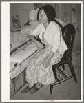Mexican woman in bedroom. Notice the dirt floor. Crystal City, Texas
