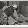Mexican mother covering sleeping child. Crystal City, Texas