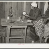Mexican woman setting clock. Crystal City, Texas