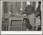 Mexican woman setting clock. Crystal City, Texas