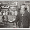 Old-time trail driver in front of kitchen cabinet. Crystal City, Texas