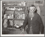Old-time trail driver in front of kitchen cabinet. Crystal City, Texas