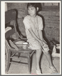 Mexican child with dried beans which play a large part in the Mexican diet. Crystal City, Texas