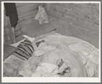 Bed in Mexican home. In practically all Mexican homes the beds consist of old blankets and quilts that are spread upon the bare floors. Crystal City, Texas