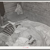 Bed in Mexican home. In practically all Mexican homes the beds consist of old blankets and quilts that are spread upon the bare floors. Crystal City, Texas