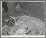 Bed in Mexican home. In practically all Mexican homes the beds consist of old blankets and quilts that are spread upon the bare floors. Crystal City, Texas