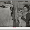 Mexican mother and child in their home. Note flies which are prevalent in all these Mexican homes. Crystal City, Texas