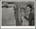 Mexican mother and child in their home. Note flies which are prevalent in all these Mexican homes. Crystal City, Texas