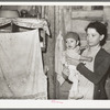 Mexican mother and child in their home. Note flies which are prevalent in all these Mexican homes. Crystal City, Texas