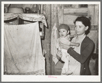 Mexican mother and child in their home. Note flies which are prevalent in all these Mexican homes. Crystal City, Texas