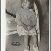 Mexican child in bed. Note dirt floor. Crystal City, Texas