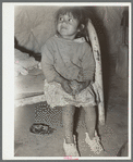 Mexican child in bed. Note dirt floor. Crystal City, Texas