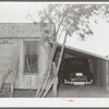House, garage and new car of Mexican. Crystal City, Texas. It is common practice for the Mexicans on returning from the beet fields of Minnesota and North Dakota and Colorado to make first payments on cars
