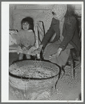 Mexican mother and child. Fires built in old galvanized tubs are used both for heat and cooking throughout the Mexican section. Crystal City, Texas