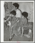 Mexican mother with her children in their home in the outskirts of San Antonio, Texas