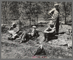 Lumberjacks resting by roadside near Littlefork, Minnesota