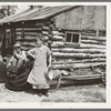 Mrs. Hale and her oldest son in front of their home near Black River Falls, Wisconsin. This farm house was built with a total expenditure of three dollars in money