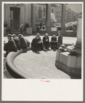 Unemployed men sitting in public square in the Minneapolis "Gateway" district, Minnesota