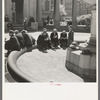 Unemployed men sitting in public square in the Minneapolis "Gateway" district, Minnesota