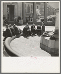 Unemployed men sitting in public square in the Minneapolis "Gateway" district, Minnesota