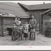 Art Simplot and family in front of their house near Black River Falls, Wisconsin