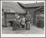 Art Simplot and family in front of their house near Black River Falls, Wisconsin