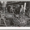 Empty cans are filled with peas and lids placed on them. Canning factory, Sun Prairie, Wisconsin