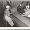 Removing inferior peas and foreign matter from peas to be canned. Canning factory, Sun Prairie, Wisconsin